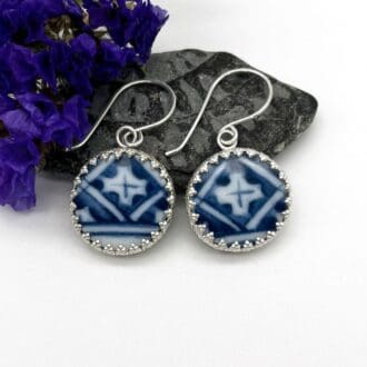round upcycled broken blue and white pottery earrings mounted in patterned silver surround
