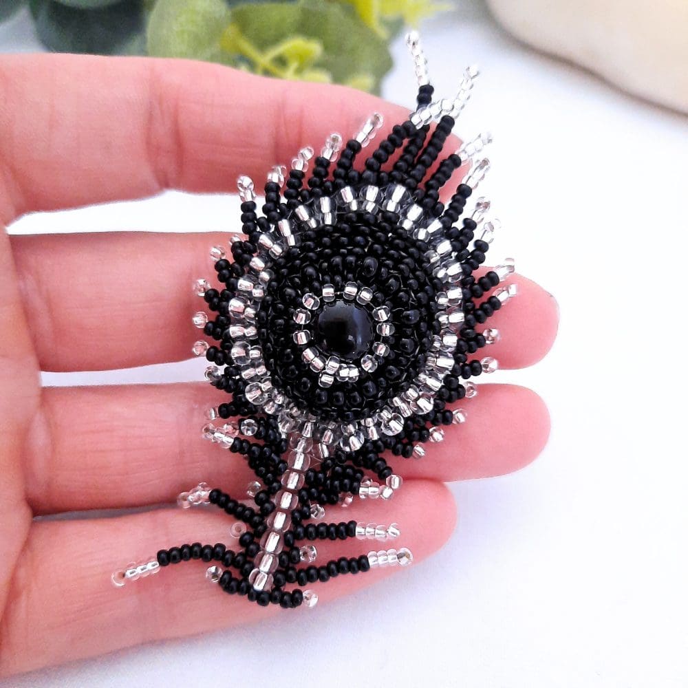 Black beaded peacock feather brooch