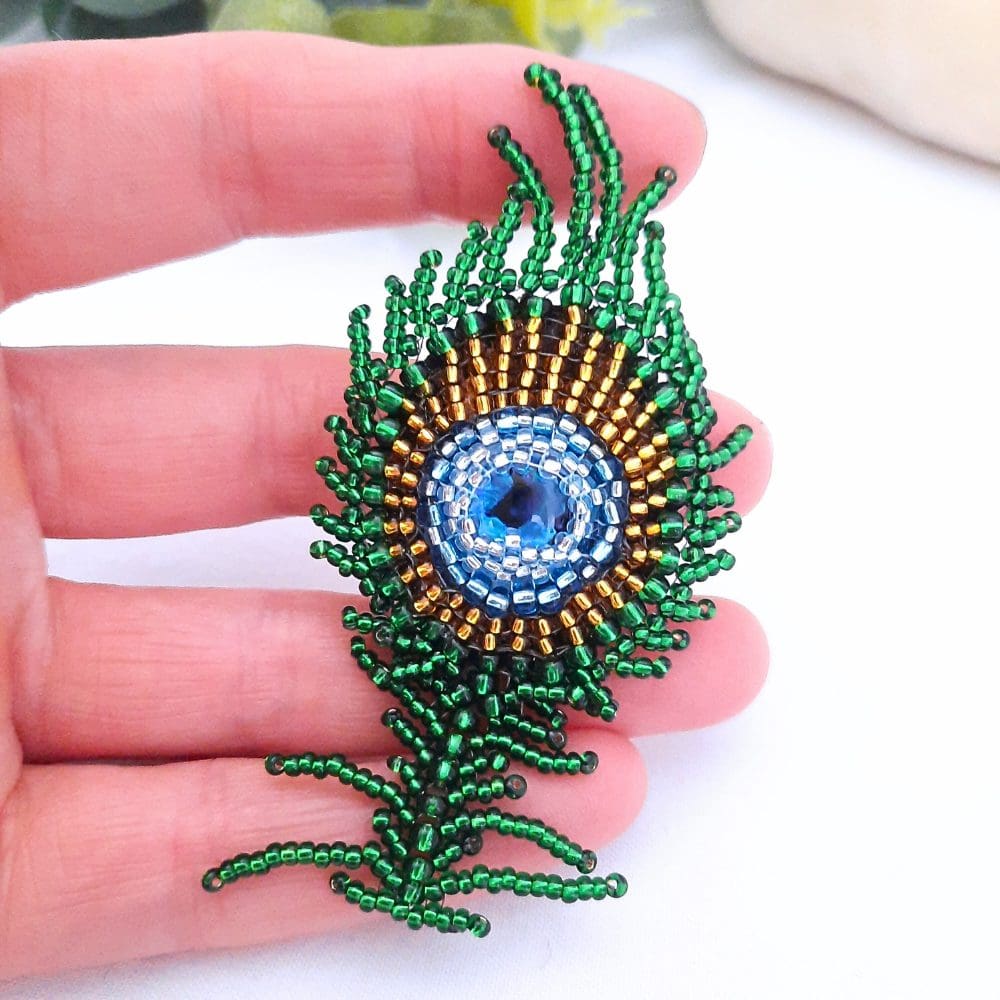 Beaded peacock feather brooch