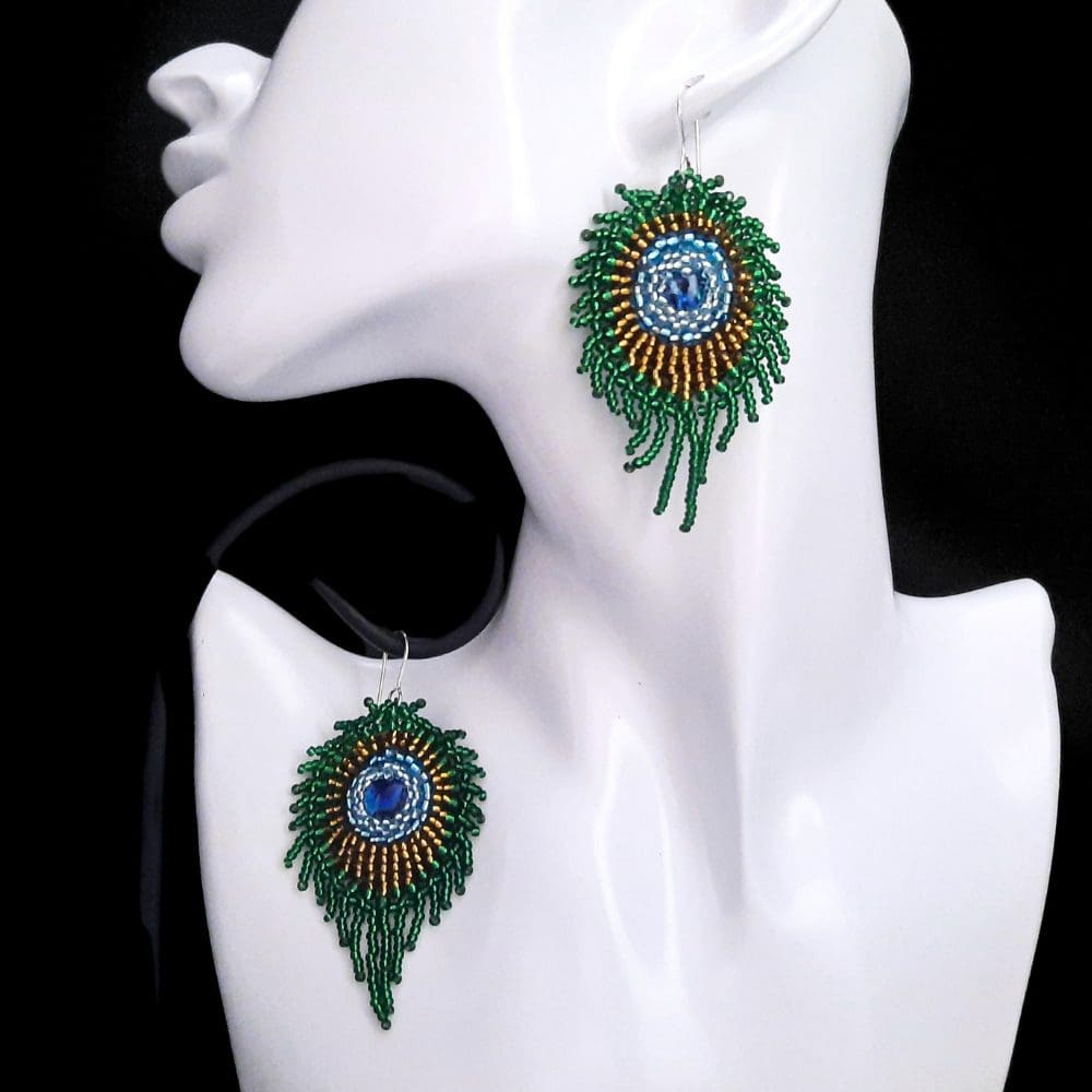 Beaded green coloured peacock feather earrings.