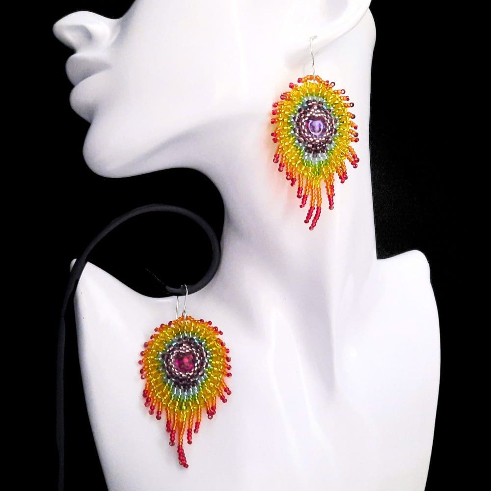 Beaded rainbow coloured peacock feather earrings.