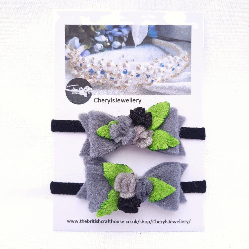 Black and grey bows and roses set on a hair elastic