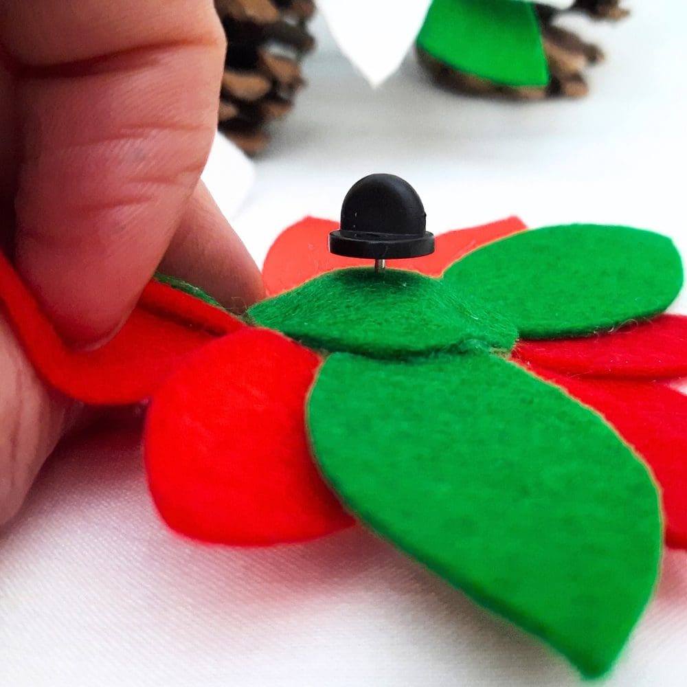 Red poinsettia pin backed brooch.