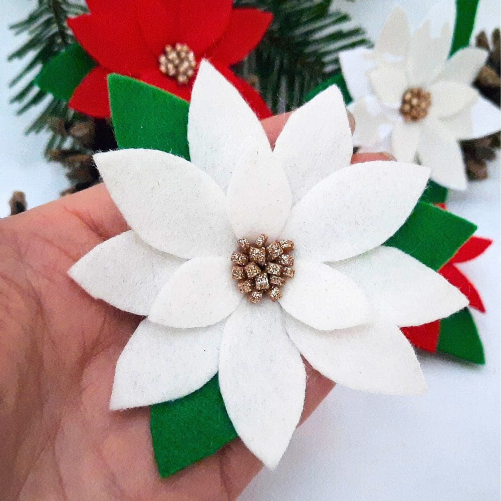 White poinsettia pin backed brooch.