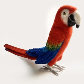 Needle felted sculpture of a red macaw parrot with blue wings, , crafted from colorful wool