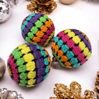 3 baubles covered in little squares of rainbow colors accented with black