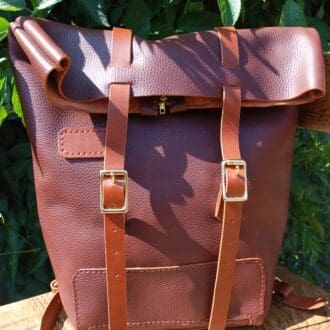 Italian leather roll top backpack with zip opening and adjustable straps