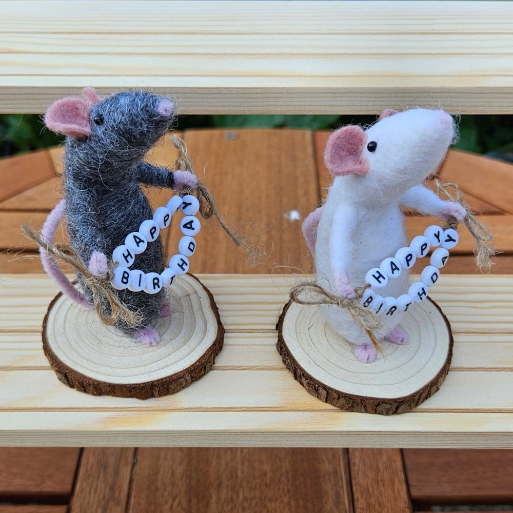 side view of Needle felted mice holding bead Happy Birthday sign