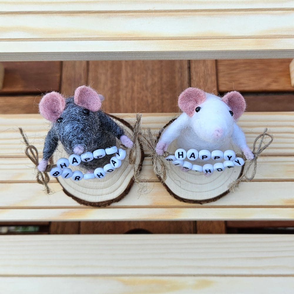 Top view of Needle felted mice holding bead Happy Birthday sign