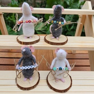 Needle felted mice holding bead names