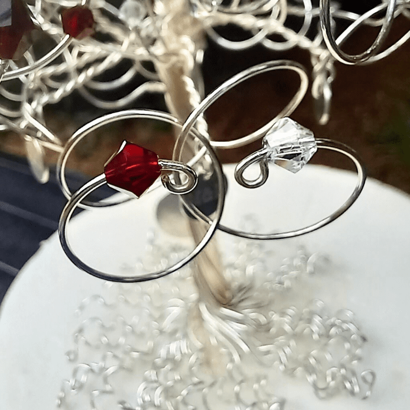 Entwined branch details, with one ruby crystal & one clear crystal