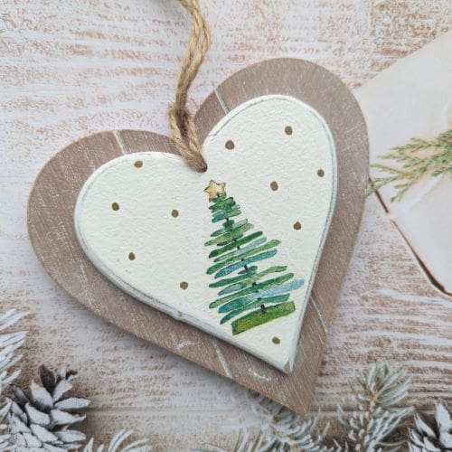 Two layer wooden hanging heart painted white and decoupaged with a Christmas tree surrounded by gold dots. Finished with a natural twine hanger
