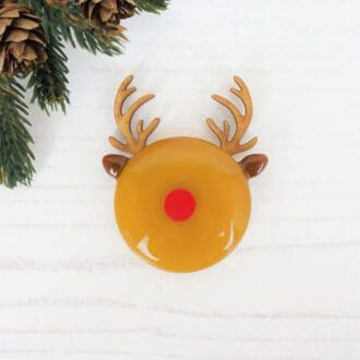 Handmade fused glass reindeer brooch with painted red nose and wooden antlers