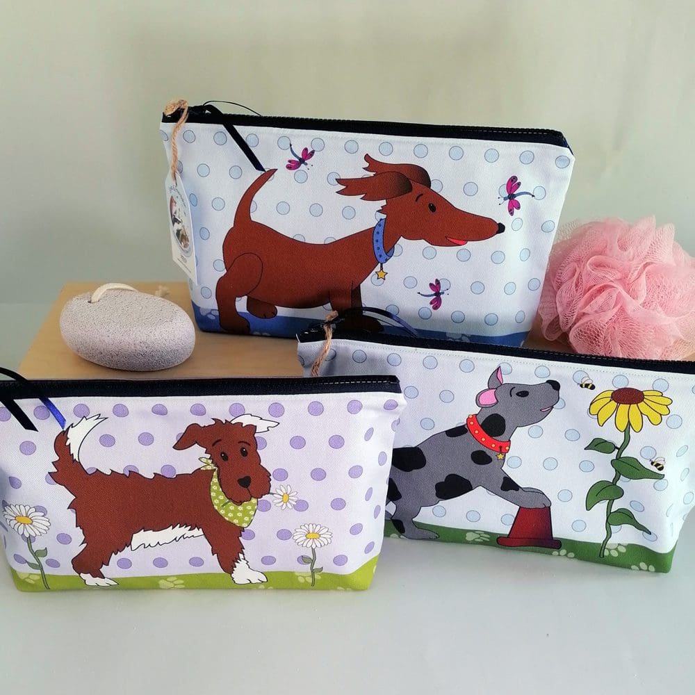 Three large toiletries bags featuring different designs of cute dogs interacting with dragonflies, bees or just looking cool in his bright green bandana. Vibrant and colourful cotton bags with water resistant lining, internal pocket and chunky zipper fastening.
