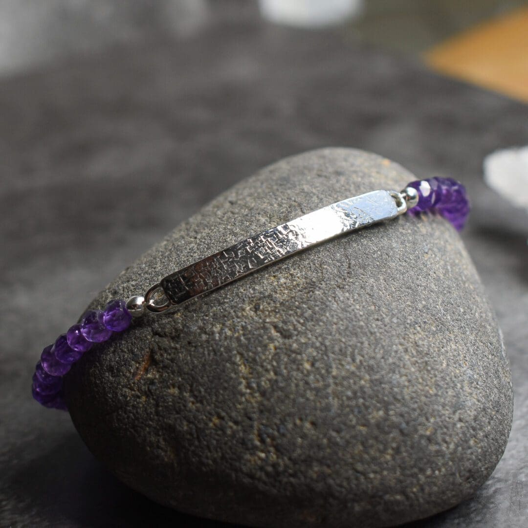 Amethyst bar bracelet with deep purple gemstones and textured Argentium Silver bar.