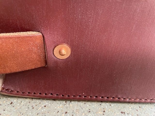 Anastasia shoulder bag showing the copper rivet detail on the side.