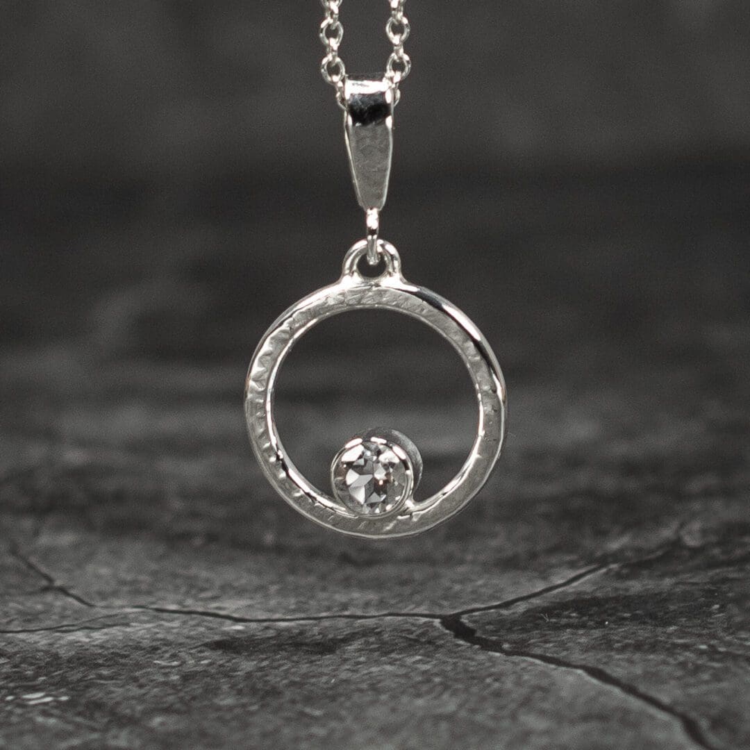 Argentium Silver Pendant with white topaz gemstone. Textured Silver Circle. Handmade in the UK.