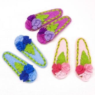 Cute hair clips covered in pink, blue or purple felt with matching roses and stitching. Gentle on delicate hair.
