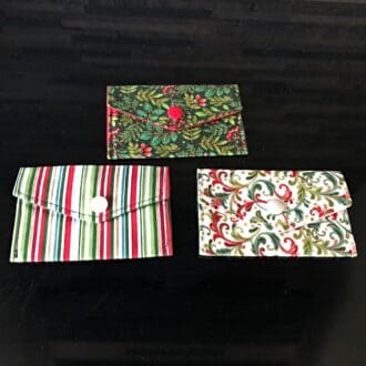Fabric gift card holders in traditional Xmas designs - stripe, holly and berries and scrolls. Closing with snap poppers