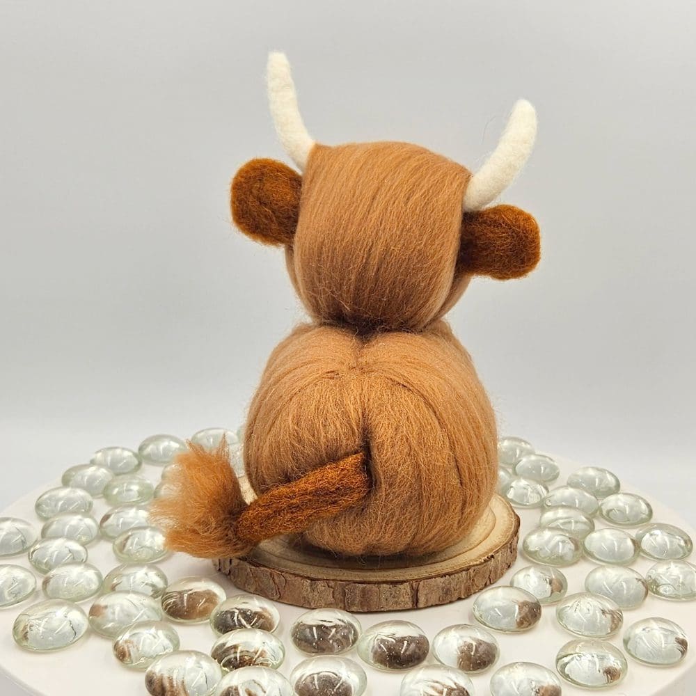 back view of needle felted highland cow traditional red