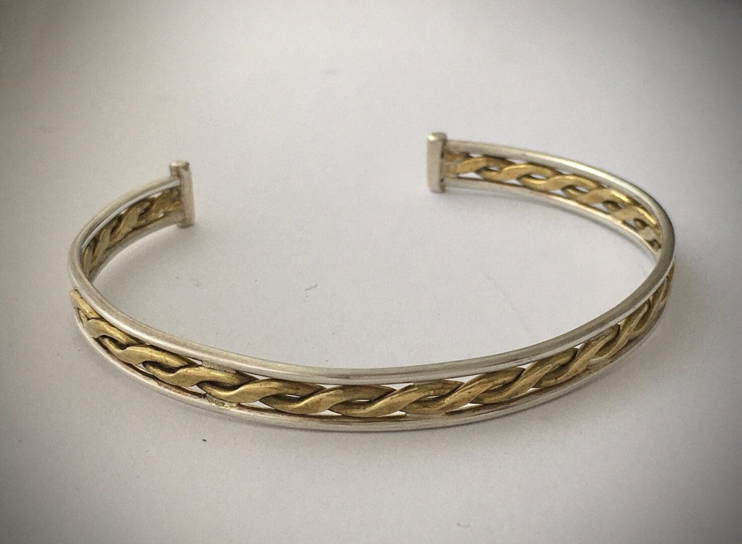 silver bangle with central brass twist