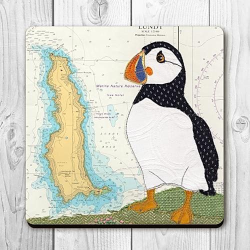 Coaster printed with a textile art design of a puffin on an old sea chart