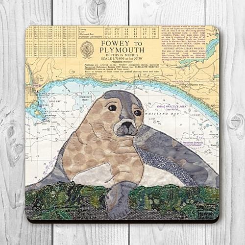 Coaster printed with a textile art design of a seal on an old sea chart