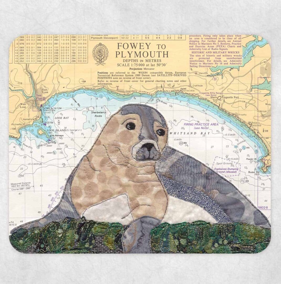 Placemat printed with a textile art design of a seal on an old sea chart