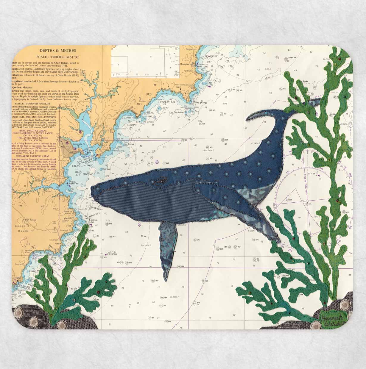 Placemat printed with a textile art design of a whale on an old sea chart