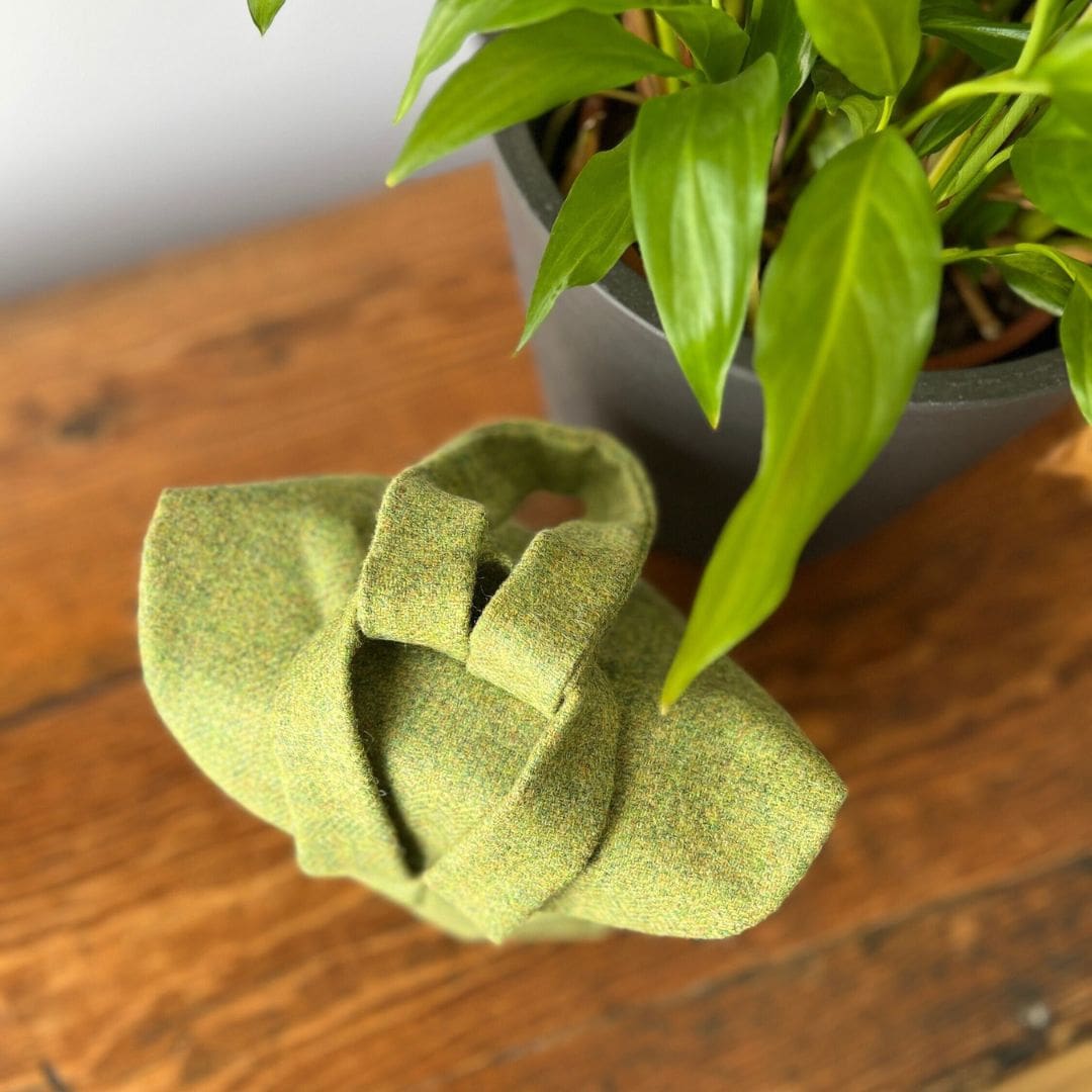 top view of a green woollen cloth bag showing the straps, one through the other