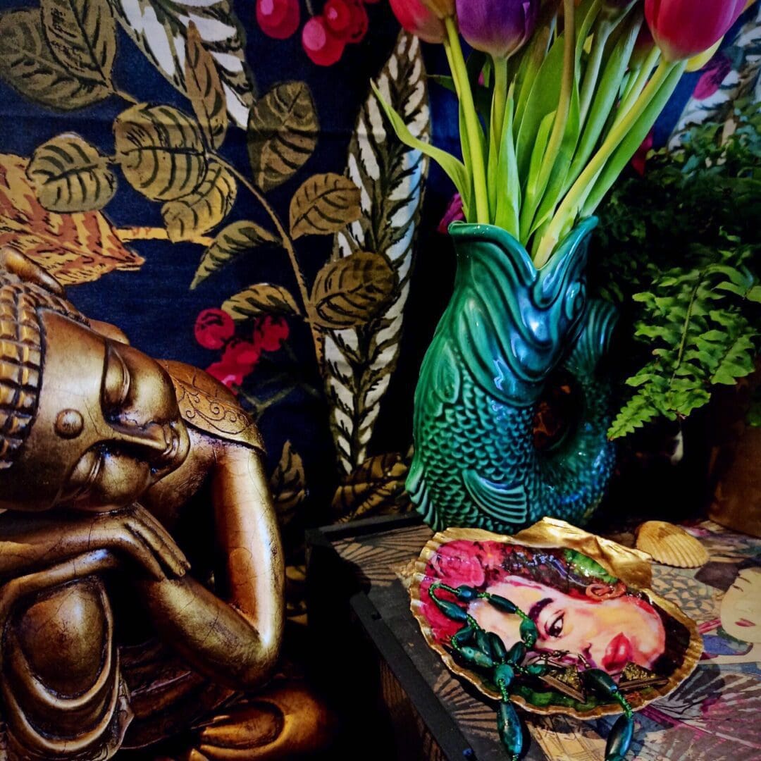 Gilded and decoupaged with Frida Kahlo design scallop shell trinket dish in a dark and eclectic, moody, maximalist setting