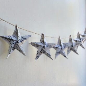 Origami music stars hanging from jute string as a garland
