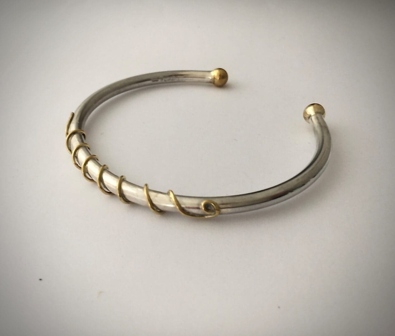 silver and brass bangle