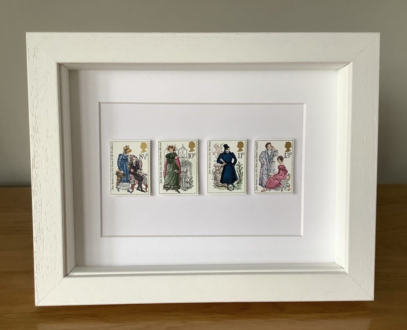 Four Jane Austen postage stamps in frame