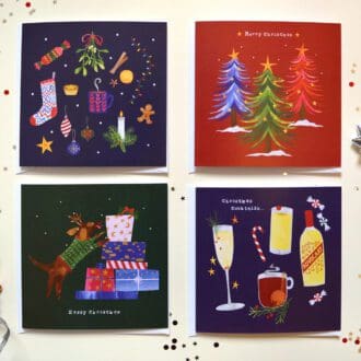 Four Illustrated Christmas cards arranged face up in a square. The cards each have a different design featuring trees, a dog with presents, festive drinks and a collection a seasonal objects.