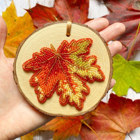 beaded autumn leaf hanging, framed on a wood slice by DewCatDesigns
