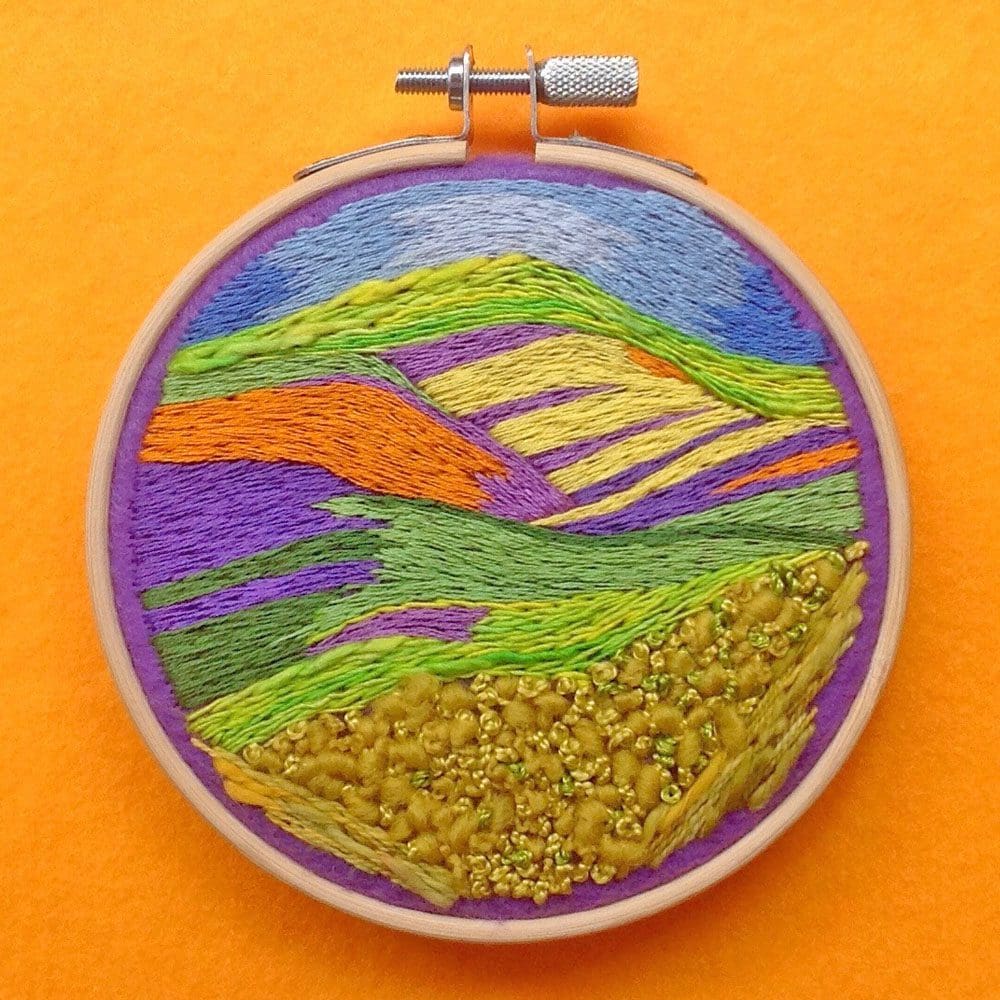hand embroidered scene inspired by a landscape of colourful wild flowers