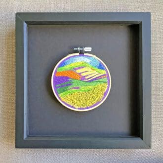 framed embroidered scene inspired by a landscape of colourful wild flowers