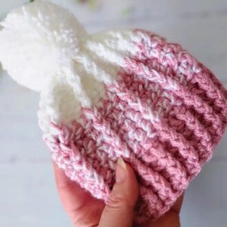 handcrafted Crochet two-tone baby hat with matching pom pom