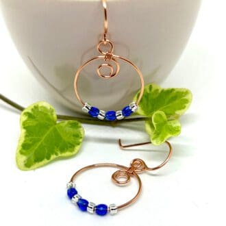 Copper hoop earrings with blue crystal beads