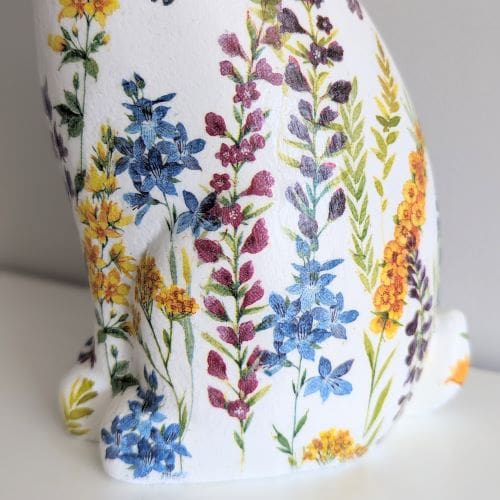Polyresin hare ornament 30cm painted white and decoupaged with a yellow, purple and blue floral design