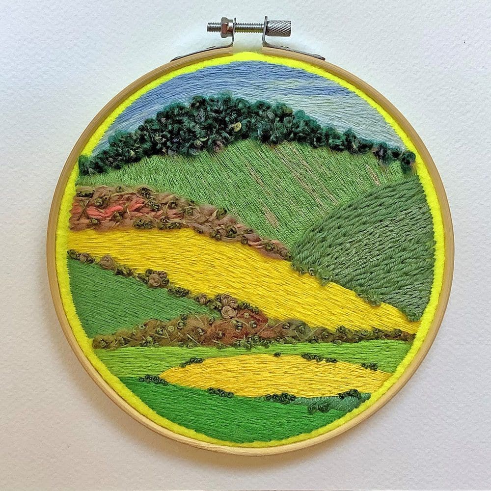 an embroidered scene depicting the South Downs