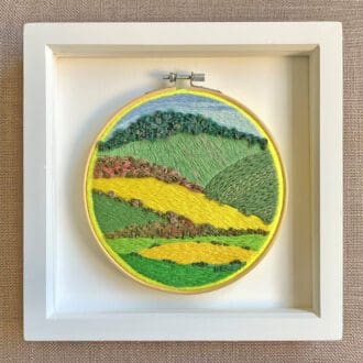 framed embroidered scene depicting the South Downs