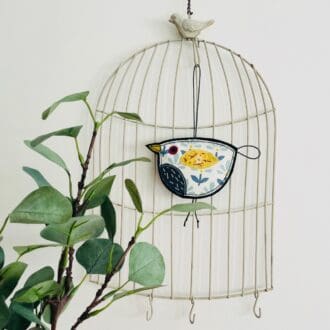 Embroidered fabric hanging bird decoration with yellow wing and blue chest