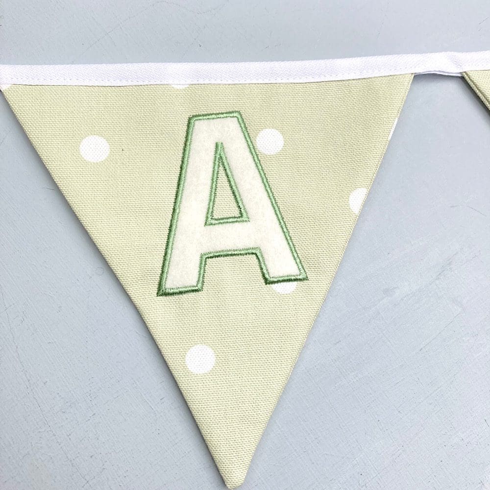 Embroidered letter on sage green bunting