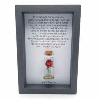 a small grey 6 x 4 frame with a miniature glass bottle containing a red rose with a personalised if roses grown in heaven quote