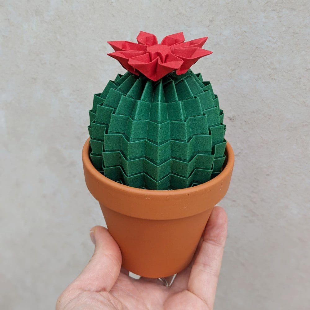 Dark green origami cactus with red flower