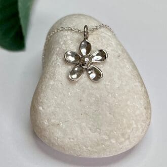 A dainty silver flower flower necklace which has been individually handmade available with 16bor 18 inch chain