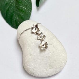 Handmade silver forget me not necklace with three dainty flowers