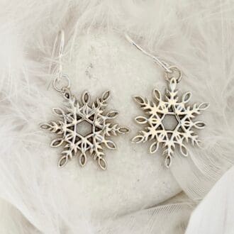 A pair of handmade silver snowflake dangle earrings